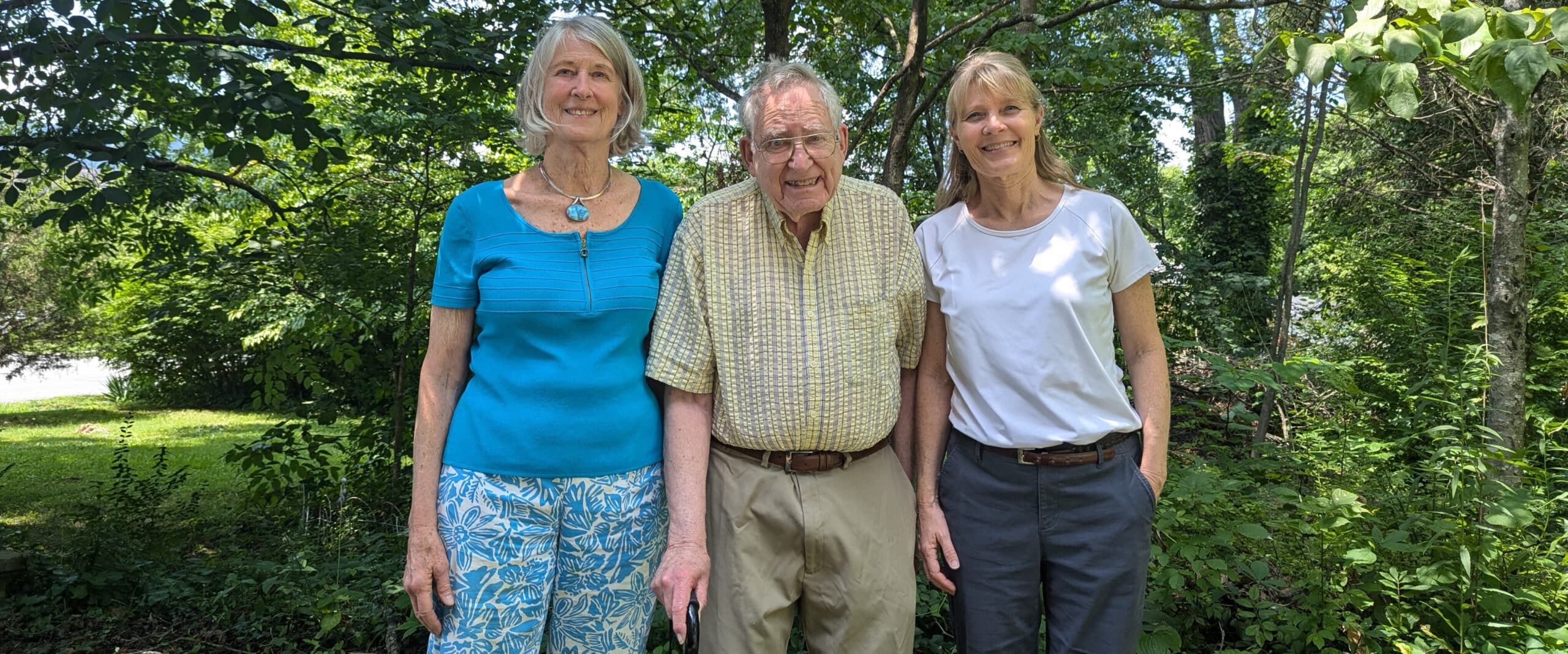 Three people in a row against a green wildlands background in Bell County, Kentucky